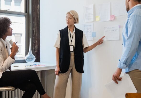Professionals discussing project plans during a team meeting in a contemporary office