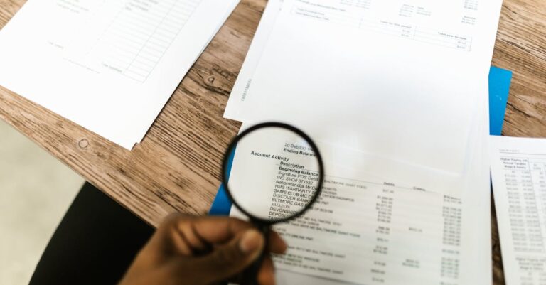 A person using a magnifying glass on a document for audit and service evidence review
