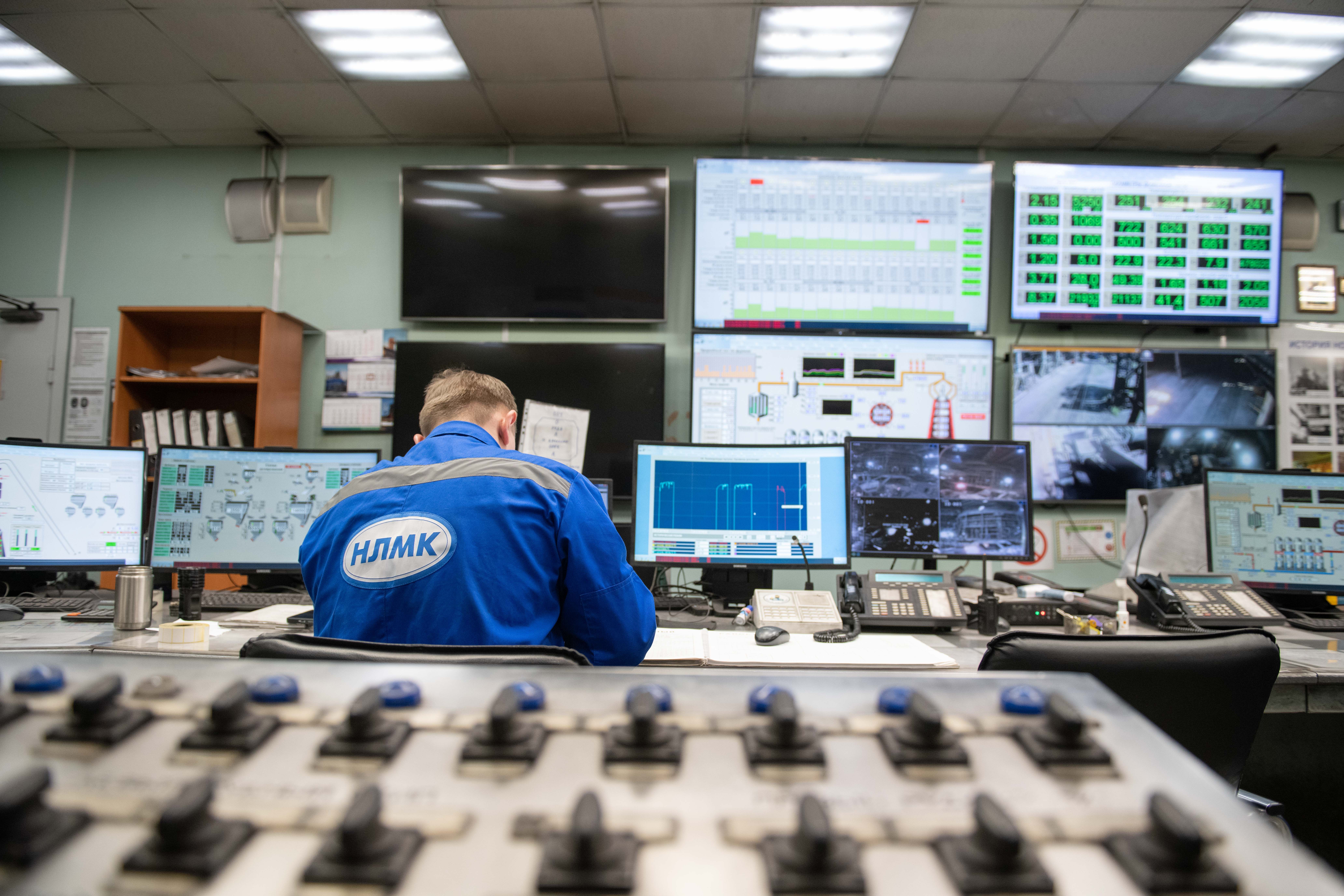 Ingenieur in industriellem Kontrollraum mit Monitoring-Screens