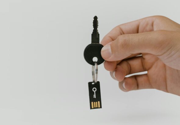 Hand hält Schlüssel mit USB-Anhänger als Motiv für Passkey-Recovery und digitale Identität