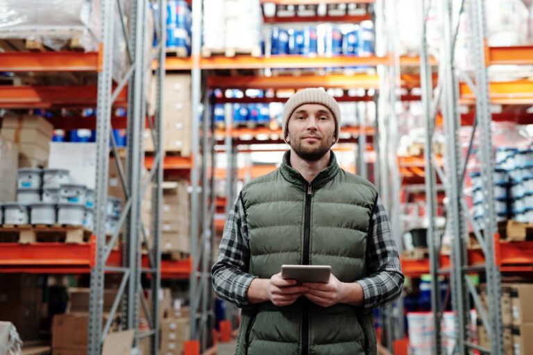 Warehouse worker with tablet symbolizing external service dependencies and operational supply chains