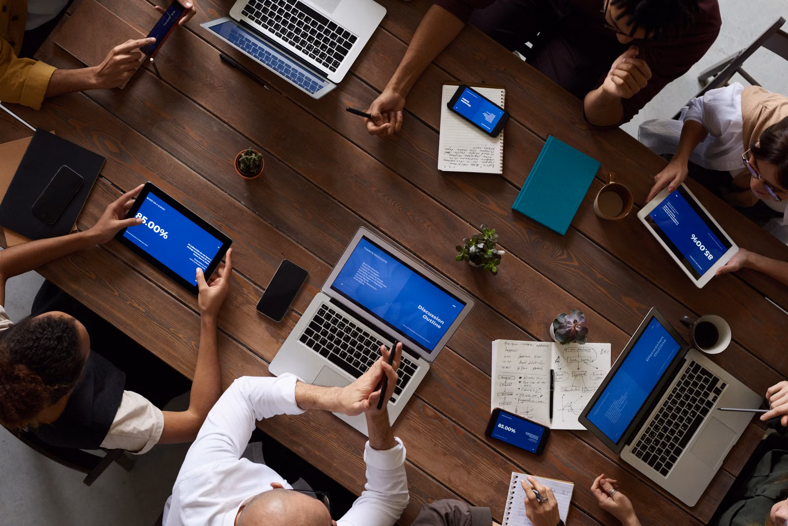Krisenmeeting mit mehreren Geräten und Notizen als Symbol für Major Incident Prozess, Lageführung und Rollenklärung im IT-Betrieb