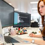 IT-Arbeitsplatz mit Monitoren als Symbol für Datenpflege, Abhängigkeiten und CMDB-Aufbau im Service Desk